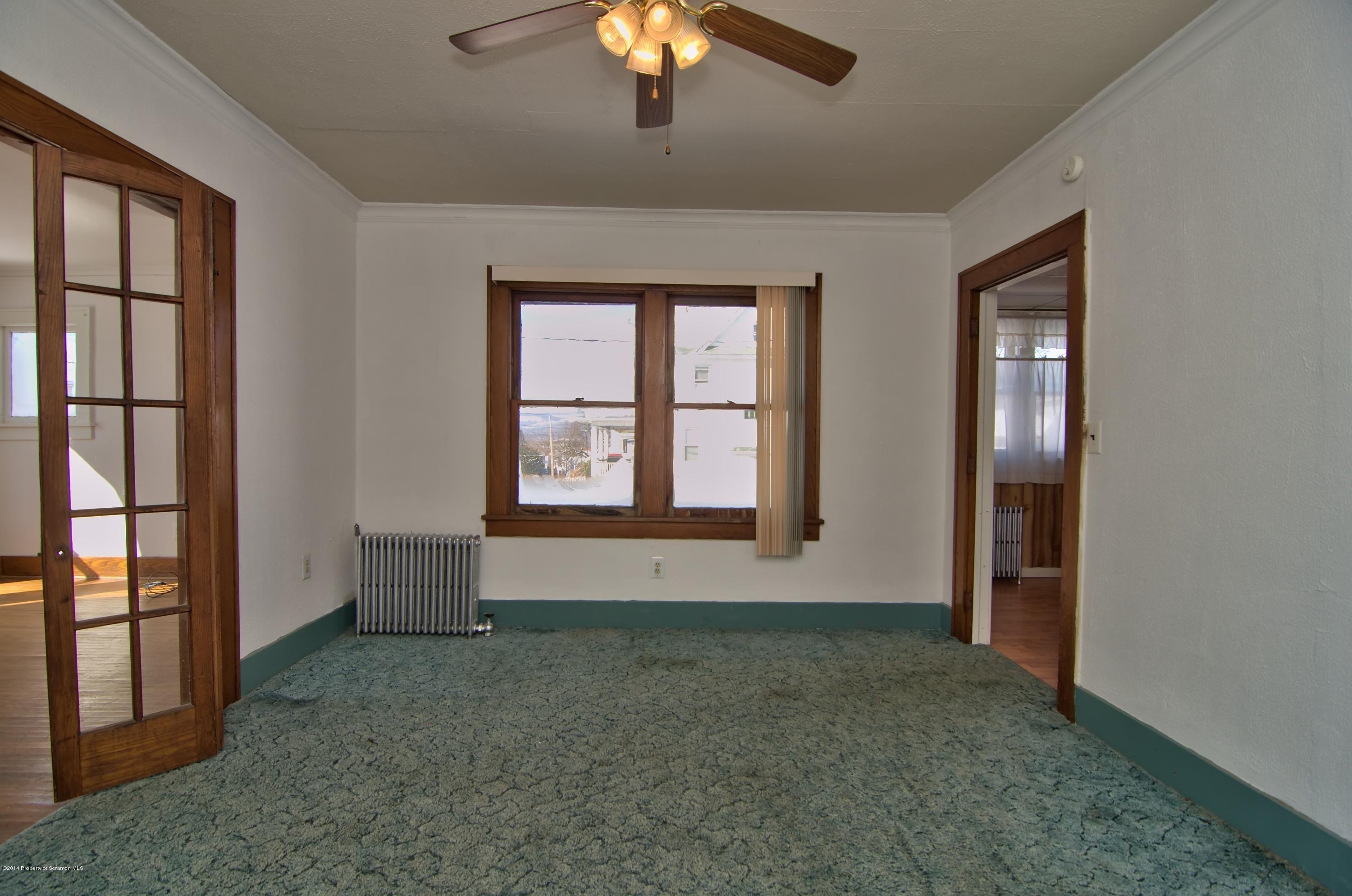 2001 Green Ridge Street Dunmore, PA 18512 - Photo 7 of 40 an empty room with chandelier fan and windows