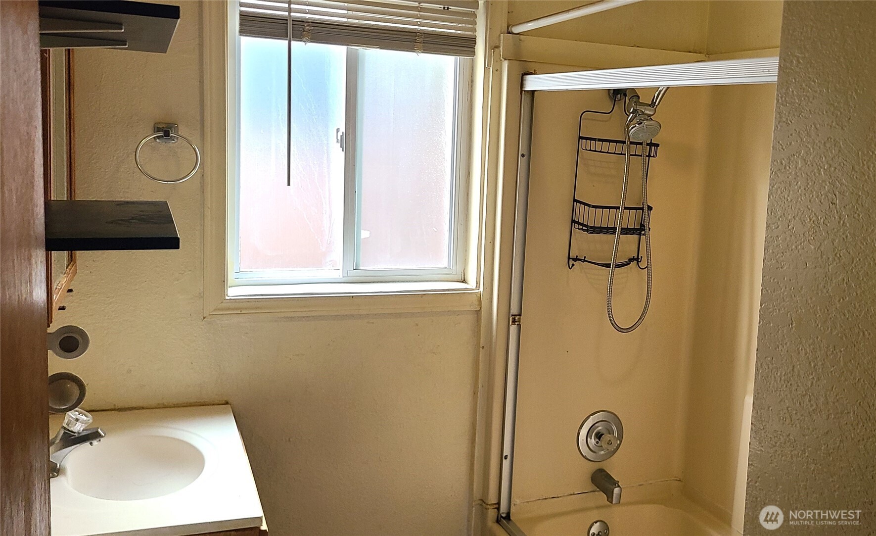 529 North 103rd Street Seattle, WA 98133 - Photo 11 of 22 a bathroom with a sink and shower