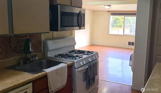 a kitchen that has a sink and a stove