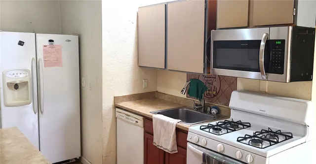 a kitchen with a stove and a refrigerator
