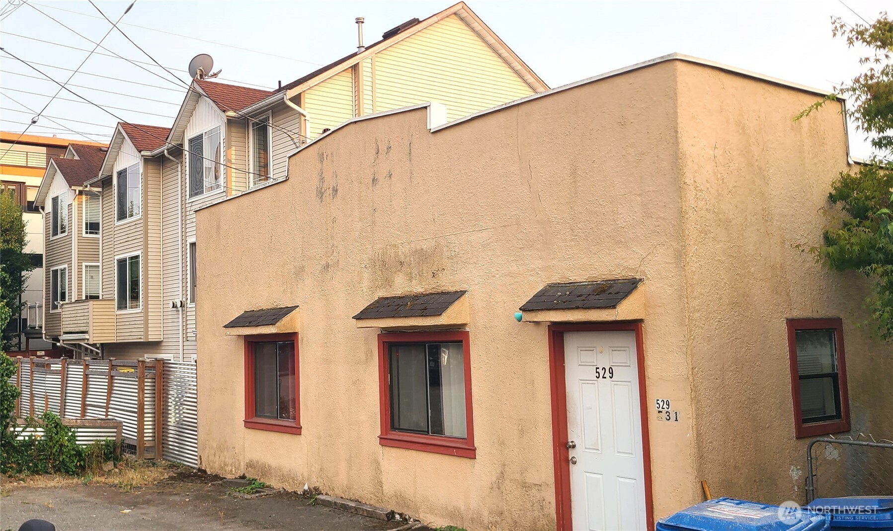 529 North 103rd Street Seattle, WA 98133 - Photo 2 of 22 a view of a blue house with large windows