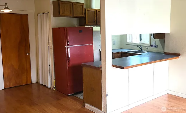 a kitchen with stainless steel appliances granite countertop a refrigerator and a sink