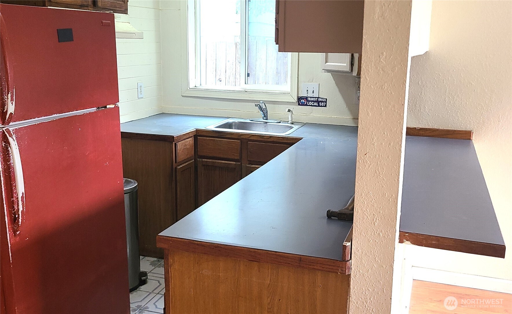 529 North 103rd Street Seattle, WA 98133 - Photo 4 of 22 a kitchen with a sink a window and a counter