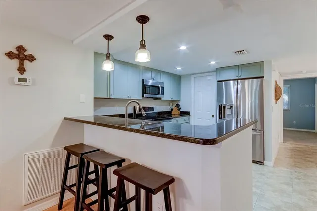 a kitchen with stainless steel appliances a sink and a stove