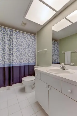 a bedroom with two beds and a ceiling fan