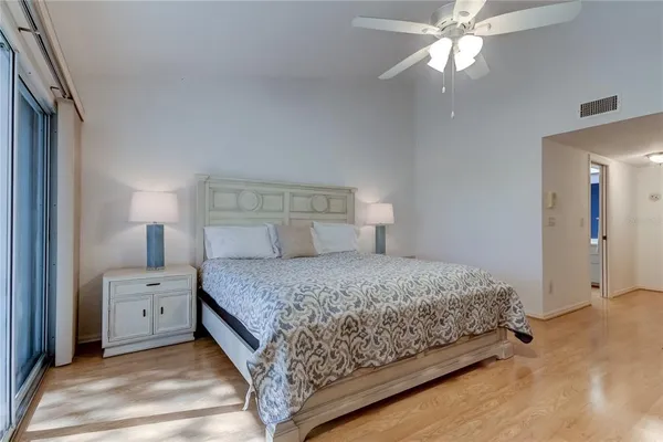 a spacious bedroom with two beds and a chandelier