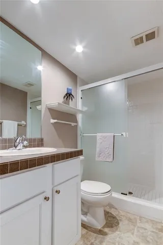 a bathroom with a toilet and a shower