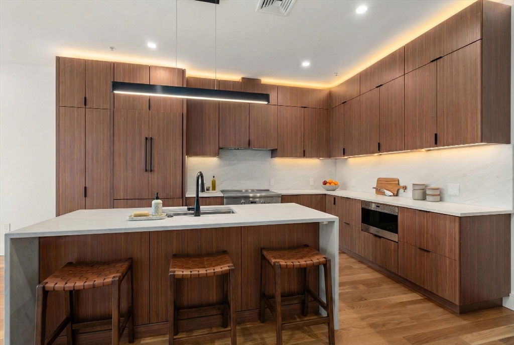 a kitchen with a sink a stove a refrigerator and cabinets