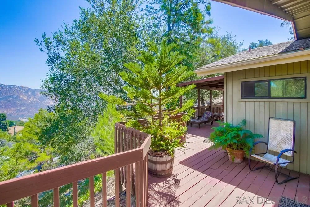 940 Mountain View Road El Cajon, CA 92021 - Photo 6 of 65 a view of a chair and table on the wooden deck