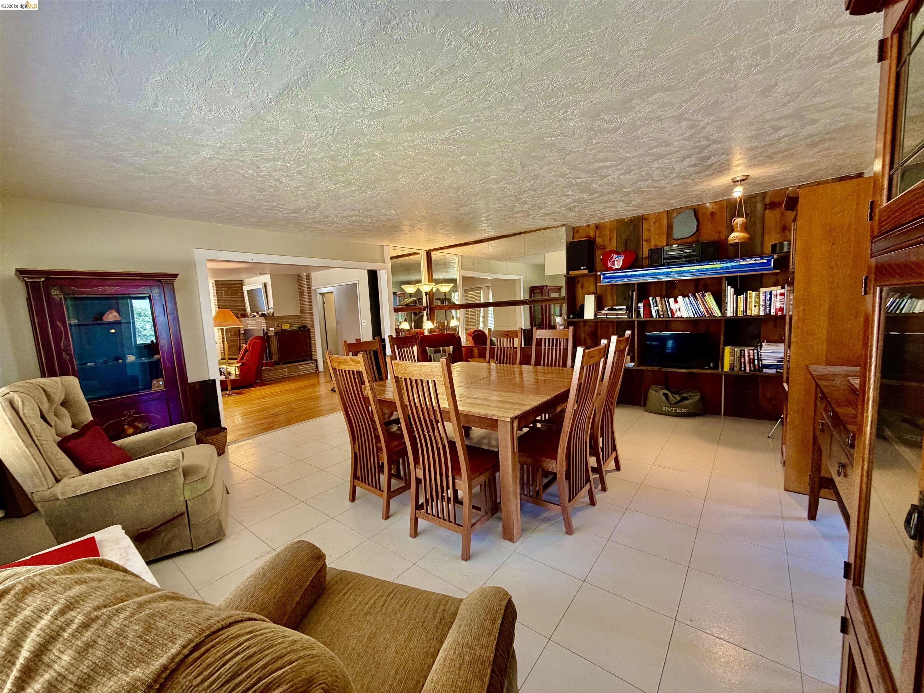 18195 Wards Ferry Road Sonora, CA 95370 - Photo 16 of 67 Dining area with light tile flooring and a wood dining table