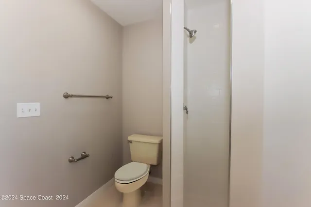 a bathroom with a granite countertop toilet