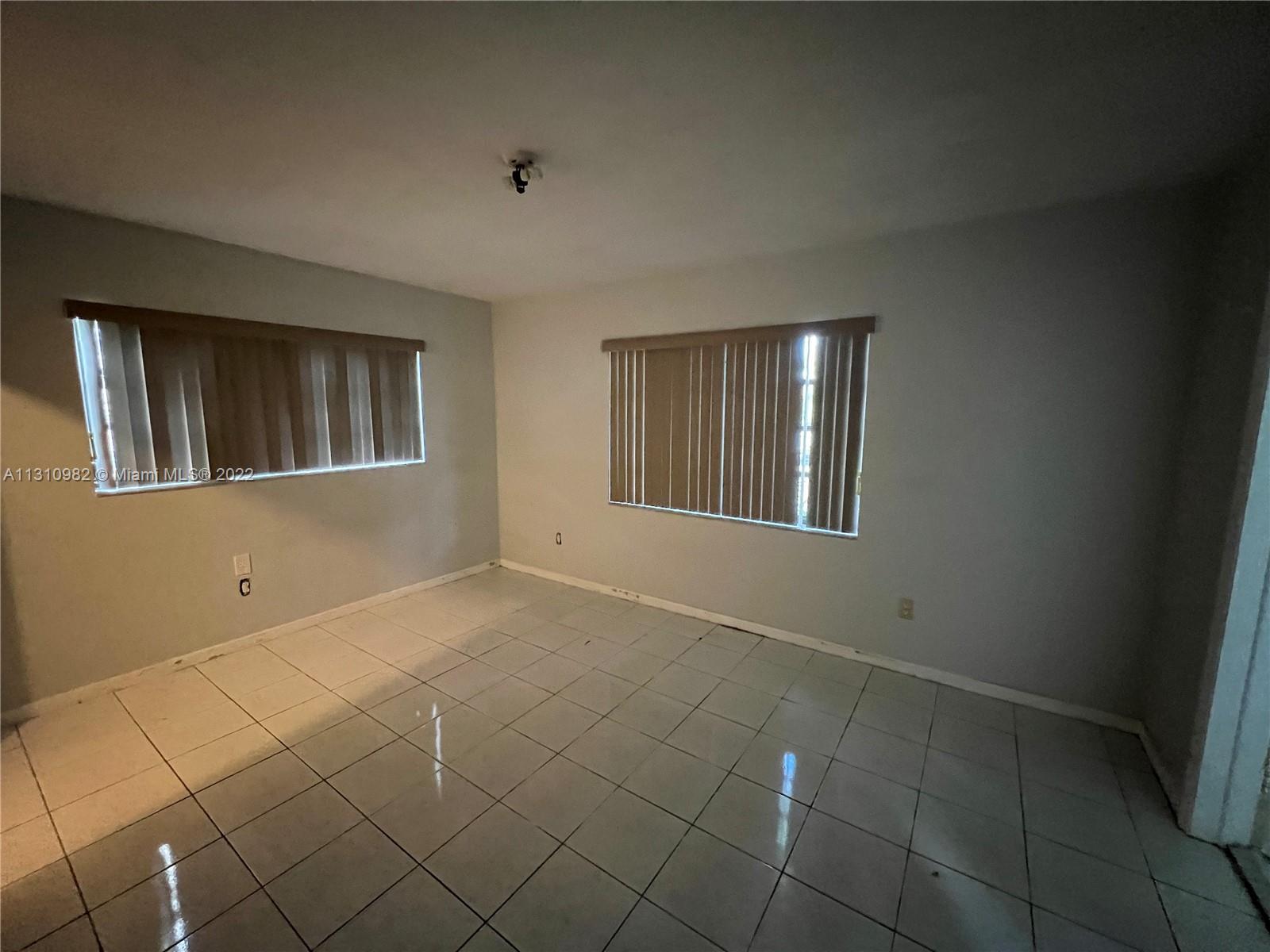 16030 Southwest 99th Avenue Miami, FL 33157 - Photo 11 of 13 a view of an empty room with windows