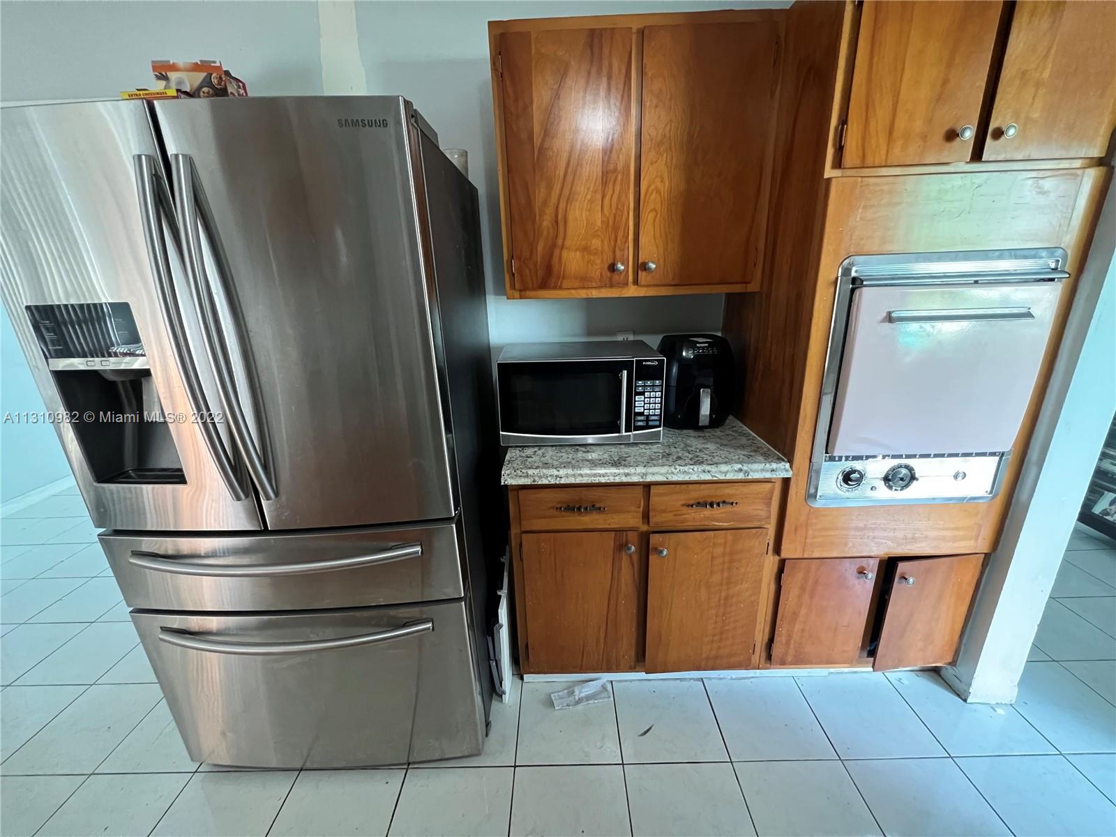 16030 Southwest 99th Avenue Miami, FL 33157 - Photo 12 of 13 a kitchen with stainless steel appliances granite countertop a refrigerator and a sink