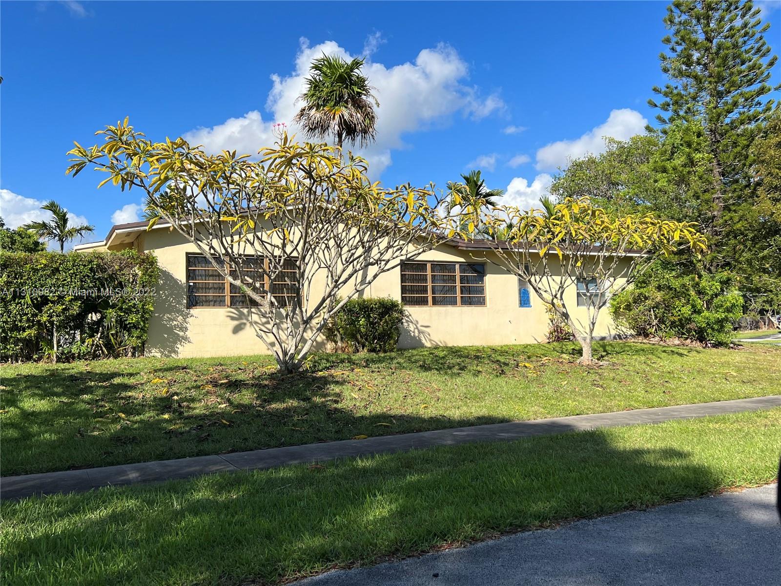 16030 Southwest 99th Avenue Miami, FL 33157 - Photo 4 of 13 a front view of a house with a garden