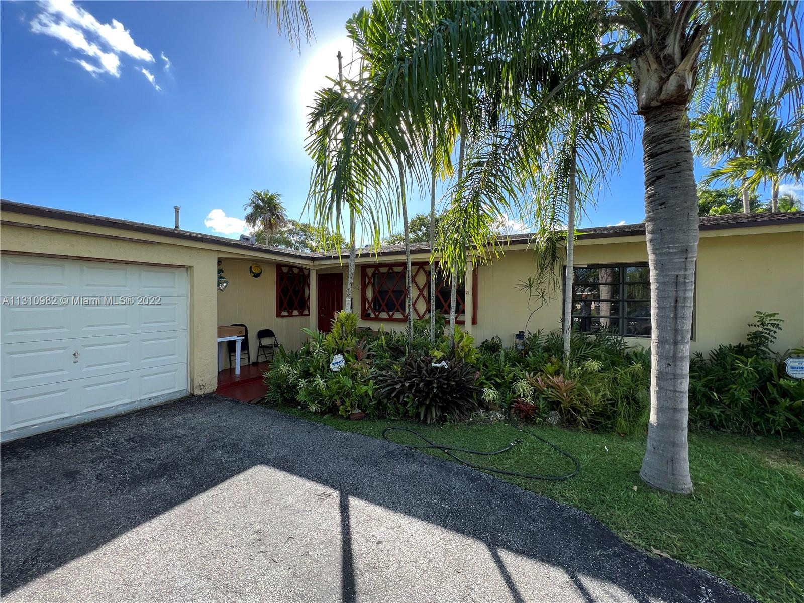 16030 Southwest 99th Avenue Miami, FL 33157 - Photo 6 of 13 a view of a house with a yard