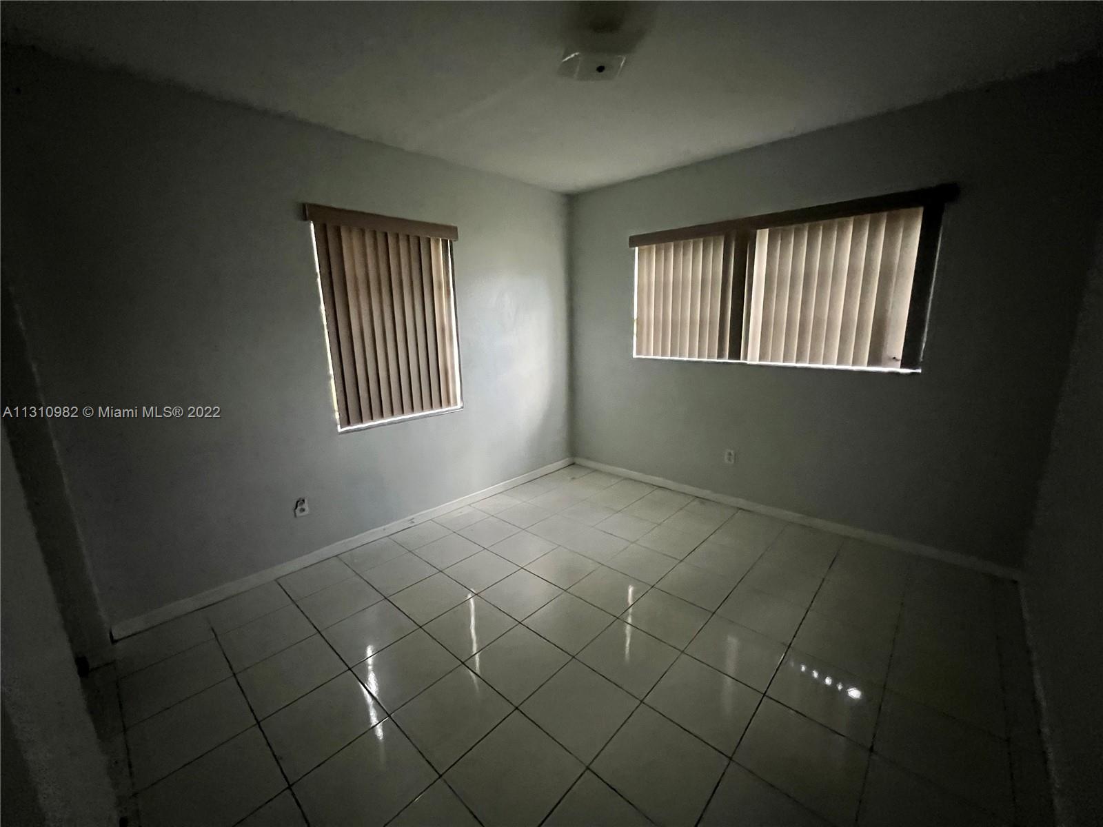 16030 Southwest 99th Avenue Miami, FL 33157 - Photo 9 of 13 a view of an empty room with a window