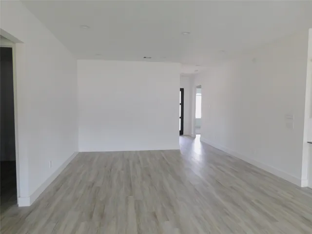 a view of an empty room and wooden floor