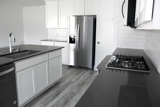 a kitchen with a sink stove and refrigerator