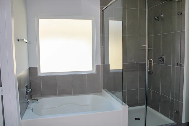 a bath tub sitting next to a window