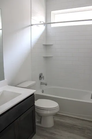 a bathroom with a sink a toilet and bathtub