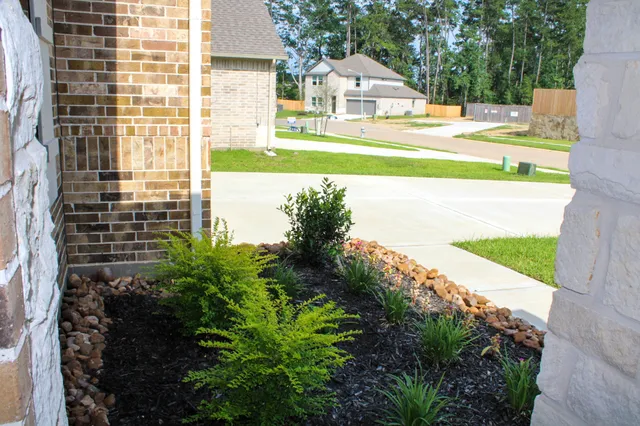 a view of residential houses with outdoor space and street view