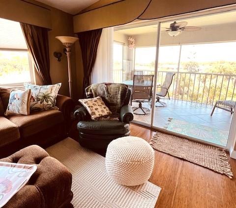 9320 Clubside Circle, Unit 2308 Sarasota, FL 34238 - Photo 15 of 51 a living room with furniture and a floor to ceiling window