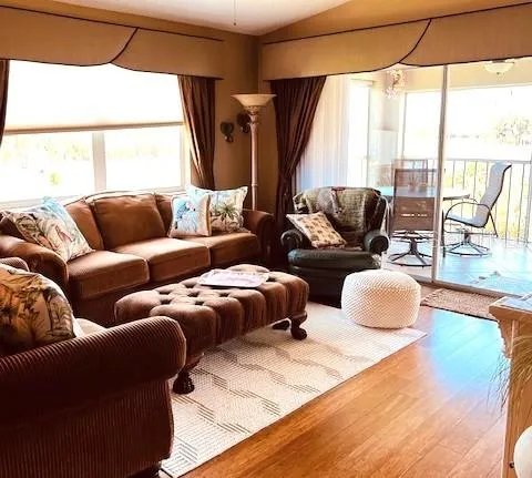 a bedroom with furniture and large windows