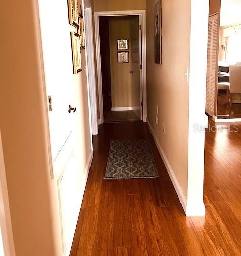 9320 Clubside Circle, Unit 2308 Sarasota, FL 34238 - Photo 2 of 51 a view of a hallway with wooden floor and staircase