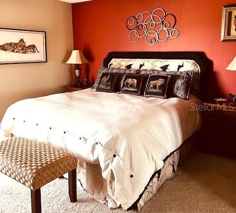 9320 Clubside Circle, Unit 2308 Sarasota, FL 34238 - Photo 21 of 51 a bedroom with a bed and painting on the wall