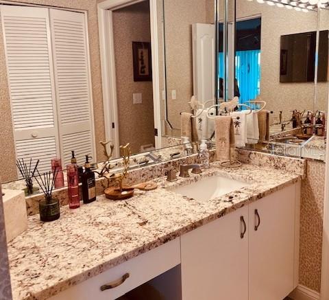 9320 Clubside Circle, Unit 2308 Sarasota, FL 34238 - Photo 23 of 51 a bathroom with a granite countertop sink and a mirror