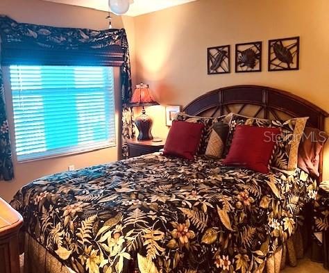 9320 Clubside Circle, Unit 2308 Sarasota, FL 34238 - Photo 24 of 51 a bed sitting in a bedroom next to a window