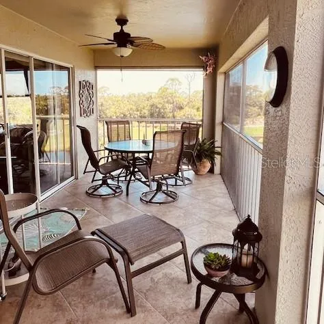 a dining room with furniture water view and a floor to ceiling window
