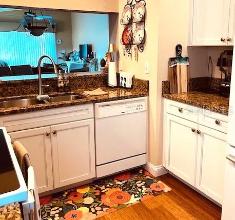 9320 Clubside Circle, Unit 2308 Sarasota, FL 34238 - Photo 9 of 51 a kitchen with granite countertop white cabinets and white appliances