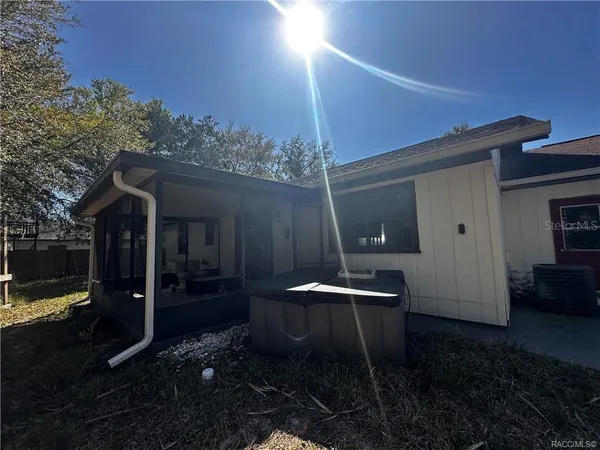 a backyard of a house with table and chairs