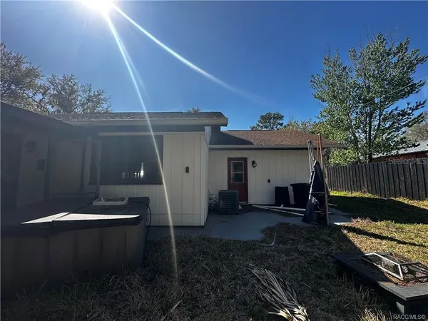 a backyard of a house with table and chairs