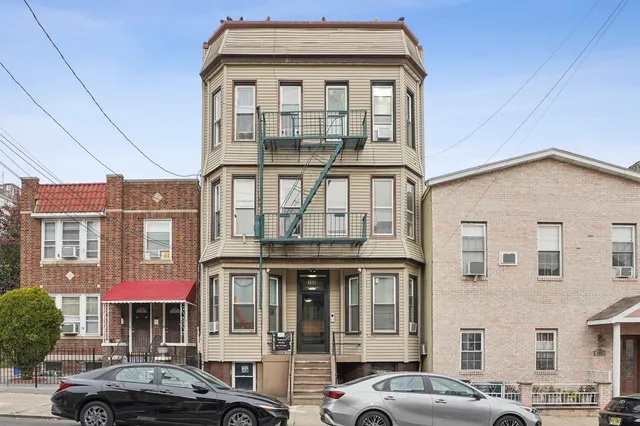 a front view of a residential apartment building with a yard