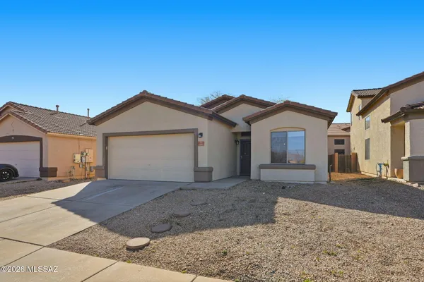 a view of a house with a yard and garage