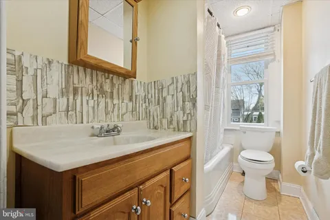 a bedroom with a bed window and lamp