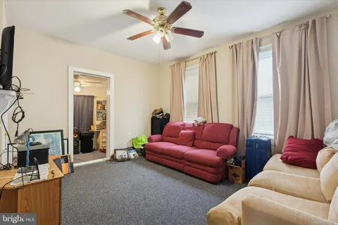 a kitchen with a dining table chairs and refrigerator