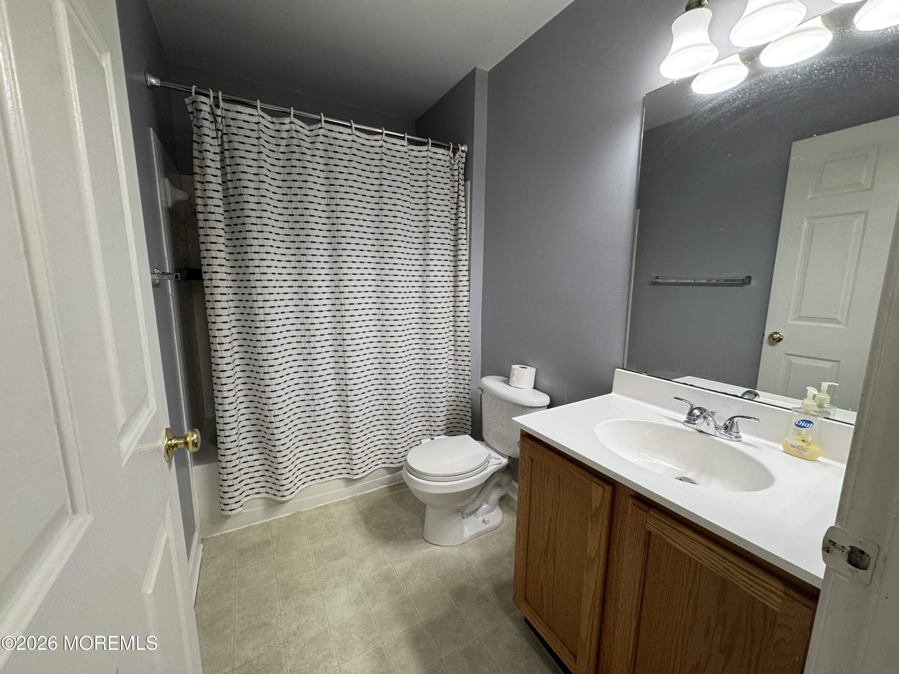 3 Skimmer Lane, Unit 38 Bayville, NJ 08721 - Photo 11 of 14 a bathroom with a sink a toilet and shower curtain