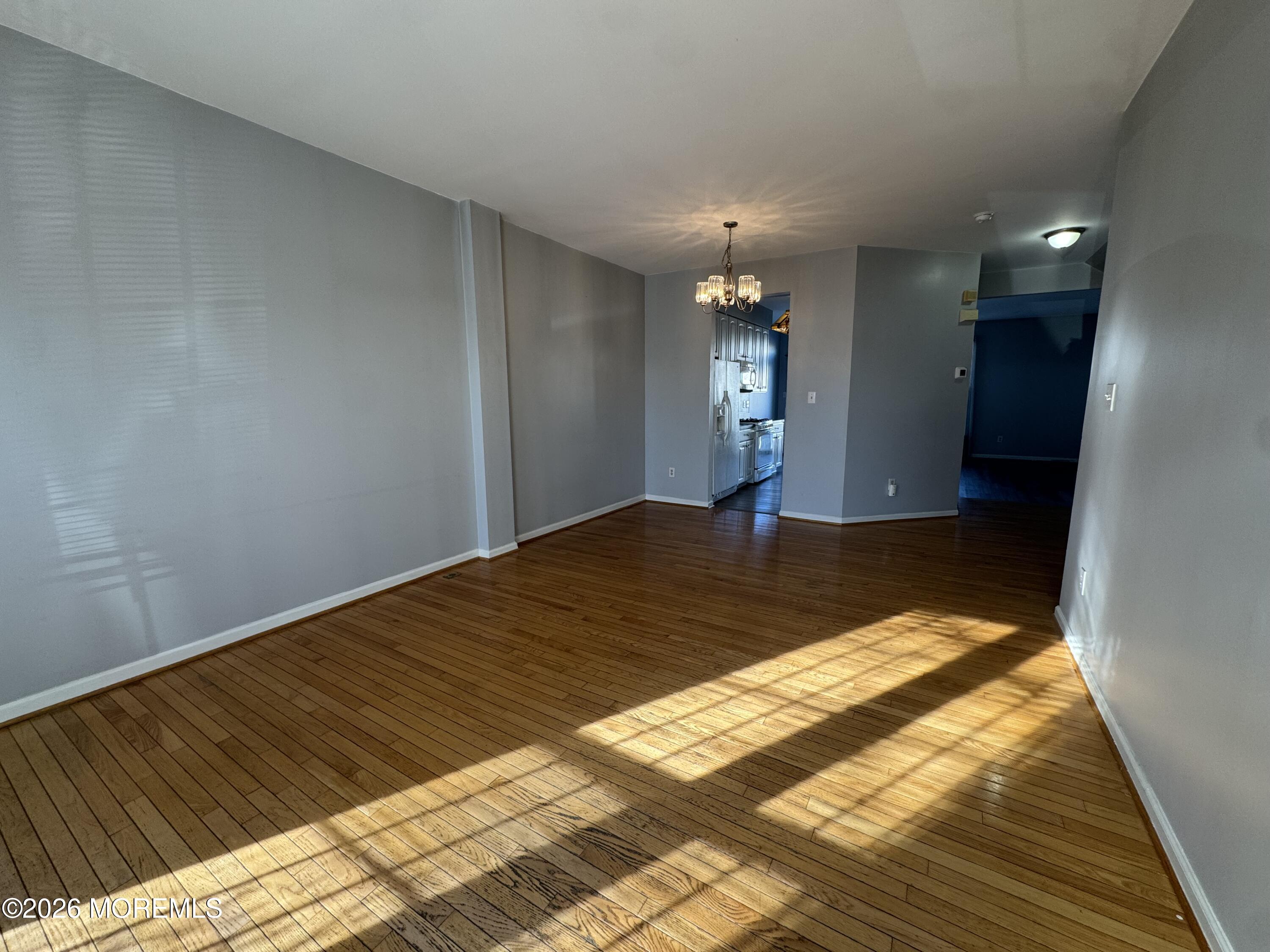 3 Skimmer Lane, Unit 38 Bayville, NJ 08721 - Photo 3 of 14 a view of a livingroom with wooden floor and chandelier