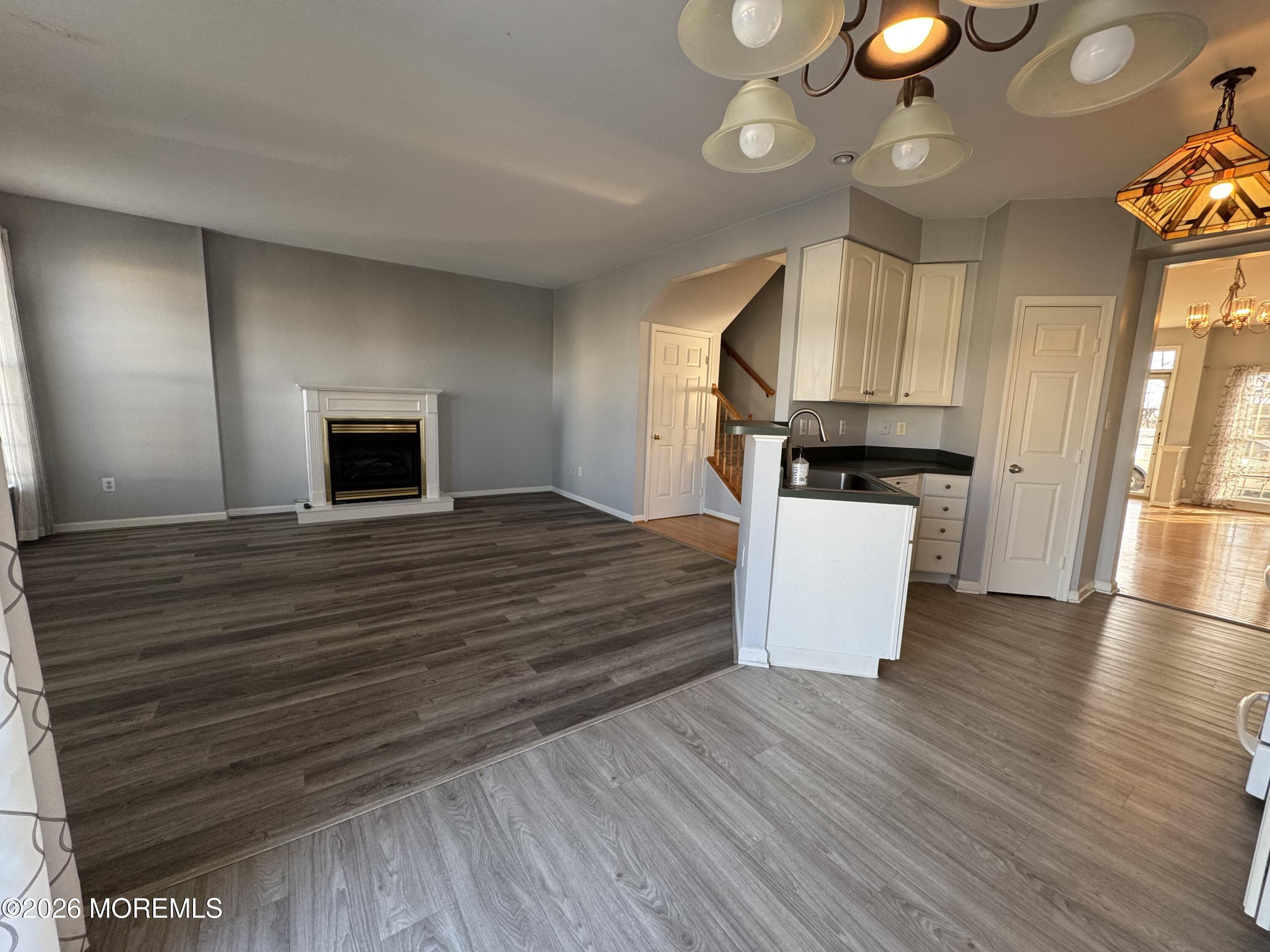3 Skimmer Lane, Unit 38 Bayville, NJ 08721 - Photo 4 of 14 a large kitchen with cabinets wooden floor and a fireplace