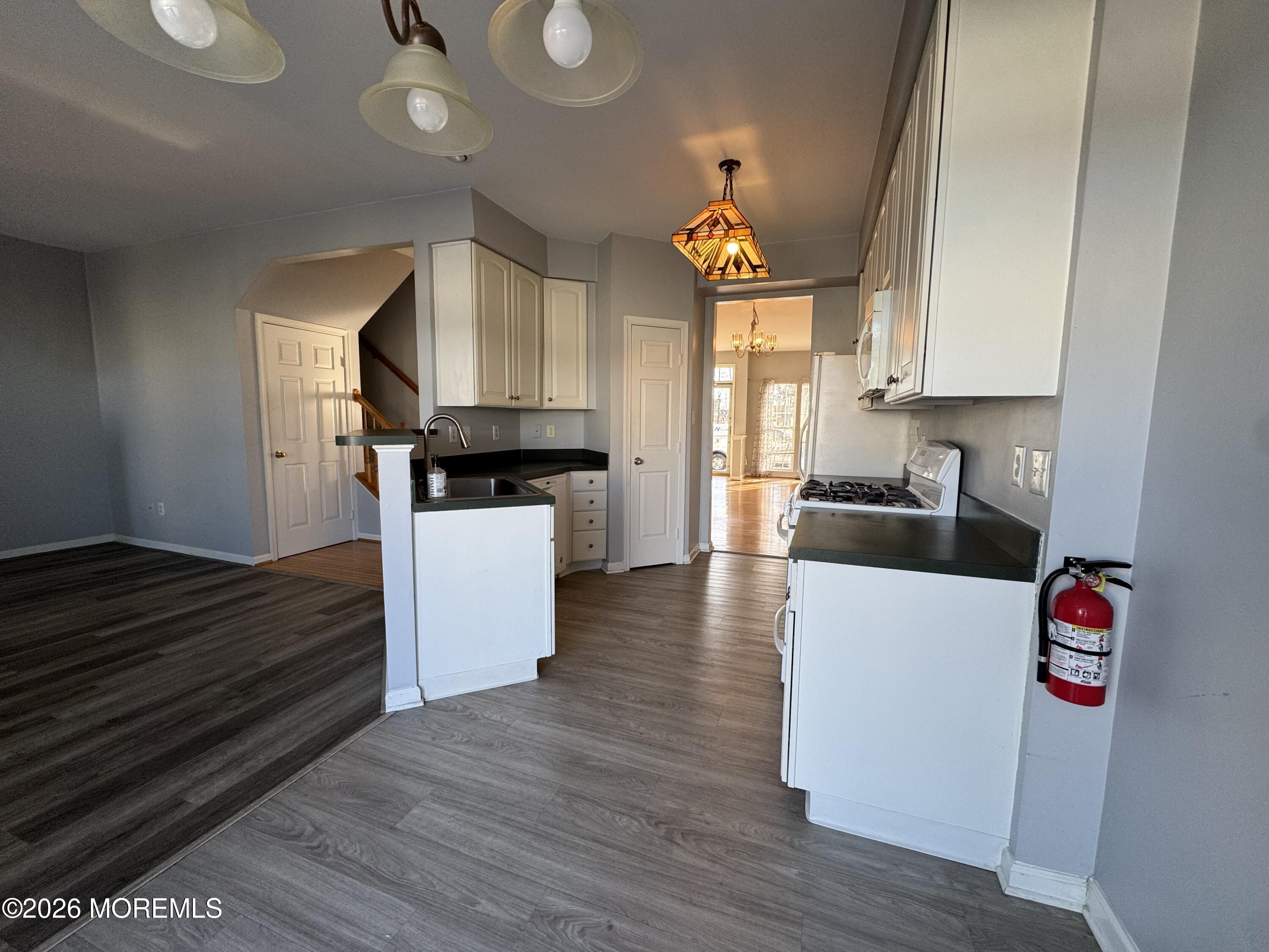 3 Skimmer Lane, Unit 38 Bayville, NJ 08721 - Photo 5 of 14 a kitchen with granite countertop a stove and a wooden floors