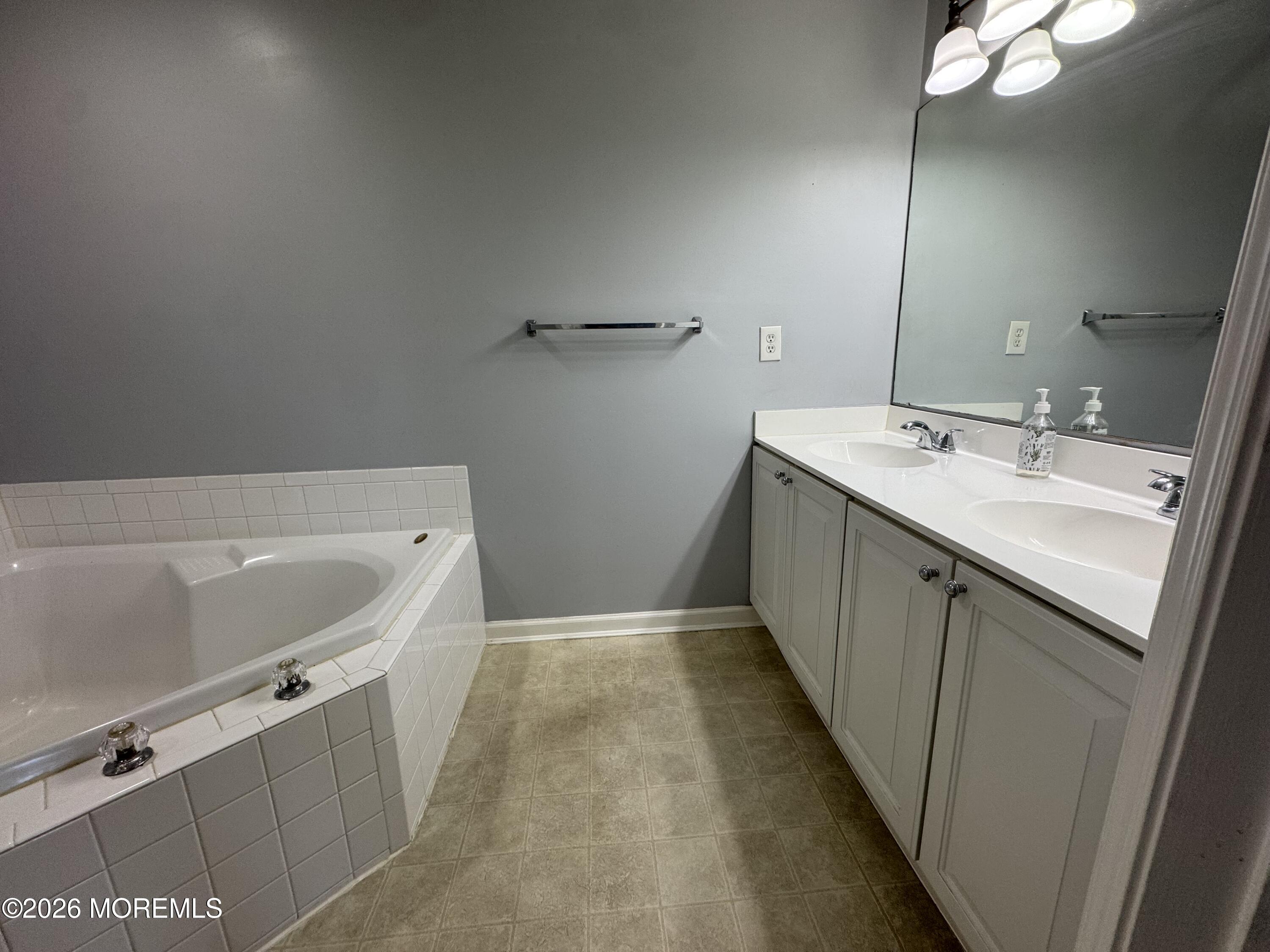 3 Skimmer Lane, Unit 38 Bayville, NJ 08721 - Photo 8 of 14 a bathroom with a tub sink and mirror