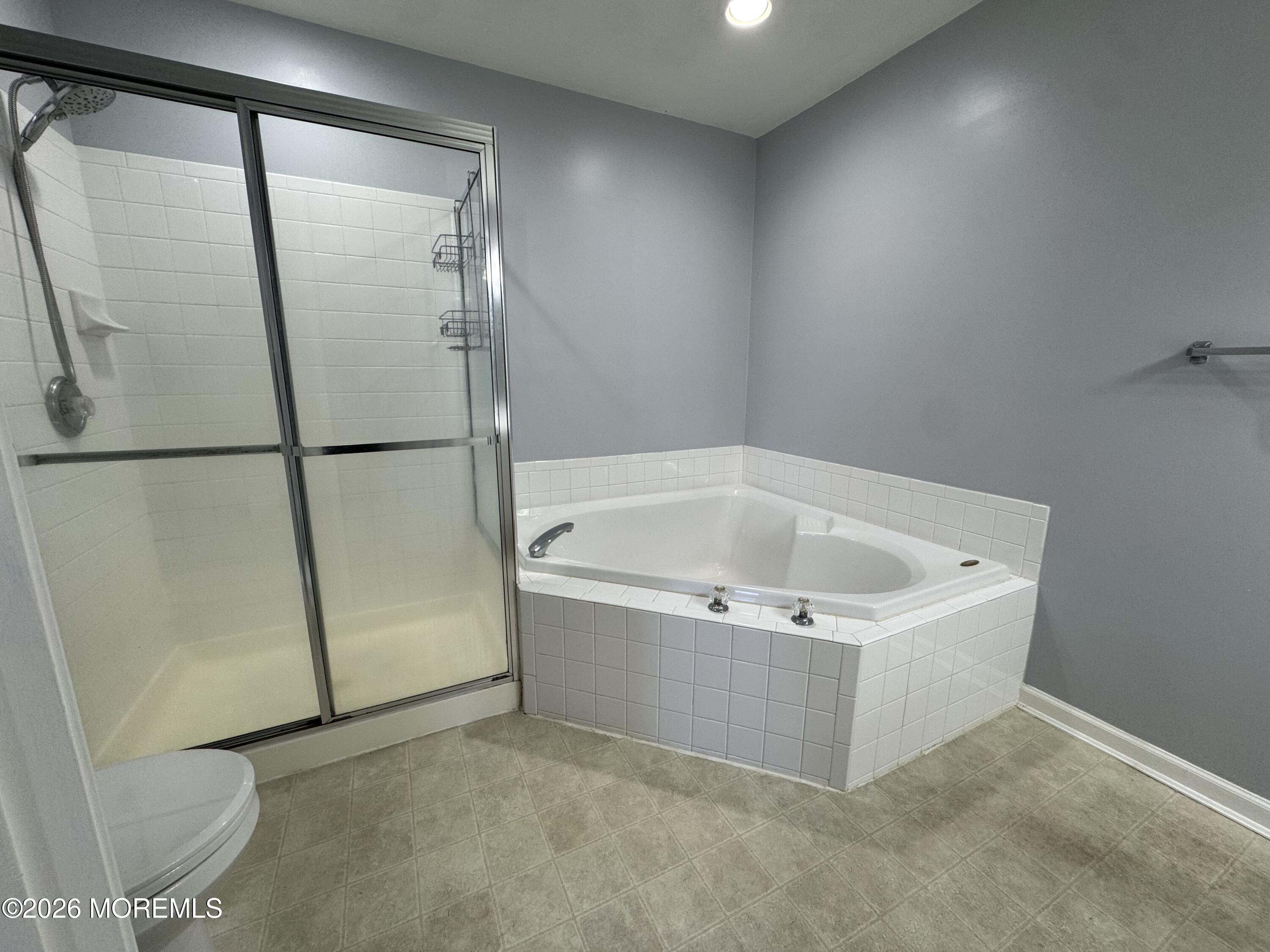 3 Skimmer Lane, Unit 38 Bayville, NJ 08721 - Photo 9 of 14 a white bath tub sitting in a bathroom