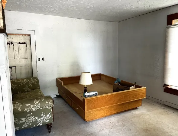 a bed sitting in a room next to a window