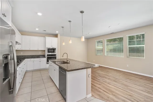 a kitchen with a sink stove and refrigerator