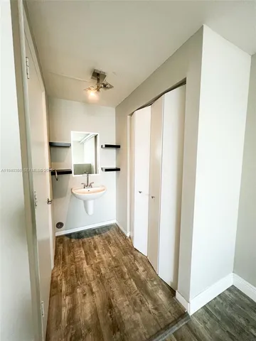 a open kitchen with white cabinets and stainless steel appliances