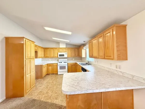 a large bedroom with kitchen island sink stove and refrigerator