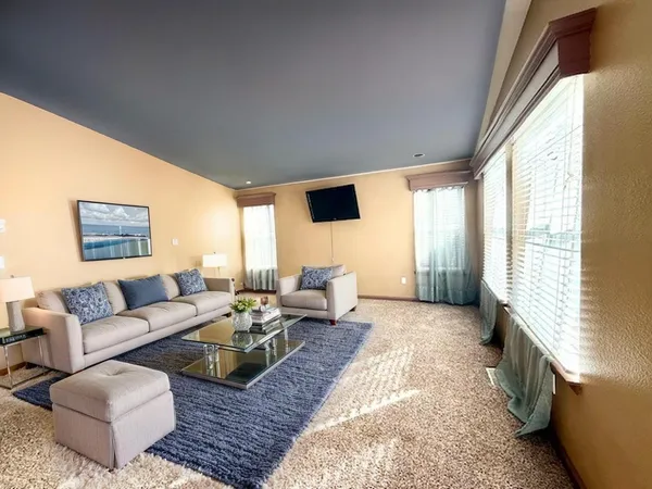 a living room with furniture or couch and a large window